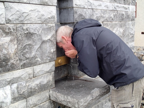 Nigel drinking the holy water at Lourdes 2019.